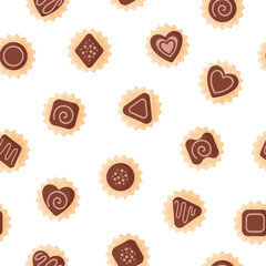 Seamless pattern of chocolates of various shapes with icing for Valentine's Day.
