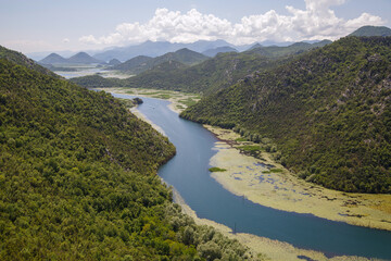 Fototapeta na wymiar Landscape with a river flowing among the mountains, Skadar Lake, Montenegro.