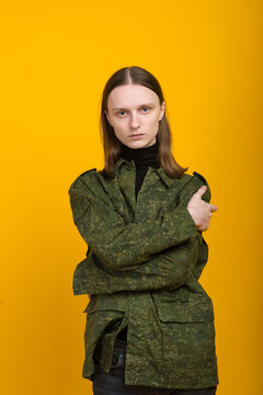 Androgen. Androgynous Character On A Yellow Background. Man Or Woman. Military Style.