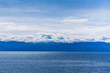 Naklejka na ściany i meble Landscape of lake Baikal sky, clouds and mountains