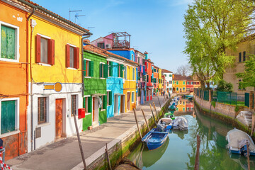 Fototapeta na wymiar Burano island in Venice (Venezia), Italy. Small colorful traditional houses along the canal