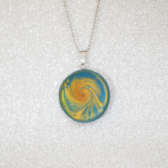 handmade polymer clay necklace pendant blue and gold swirl