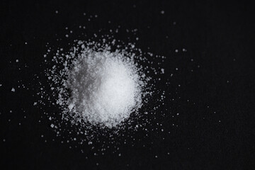 pile of sea salt on black background. selective focus