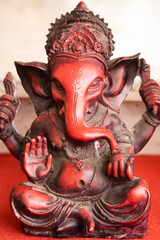 Red Colored Beautiful Statue Of Indian Hindu Lord God Idol Ganesha Ganpati Carved Out Of Earthenware Clay Stone