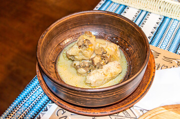 Stuffed cabbage rolls with gravy mushrooms in ceramic plate