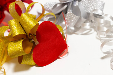 Red heart among the big bows on a white background.