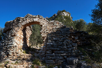 beautiful view of the arch of the lower door to the Muslim fortification of the castle of Marinyén on the mountain in Benifairó de la Valldigna, Valencian Community, Spain