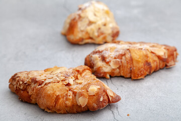 Fresh baked croissants on cement background.
