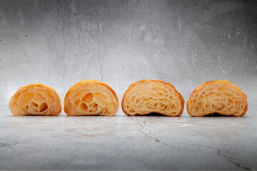 Fresh baked croissants on cement background.