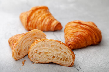 Honeycomb in sliced croissant according to the number of folds on cement background.
