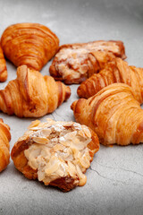 Fresh baked croissants on cement background.