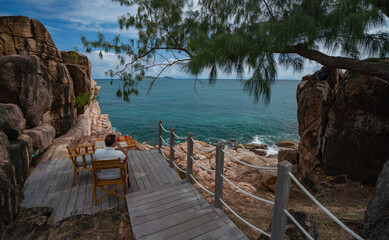 Man on a table with cocktails on the rocks Seychelles