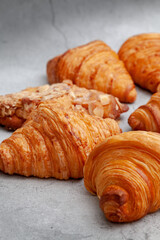 Fresh baked croissants on cement background.