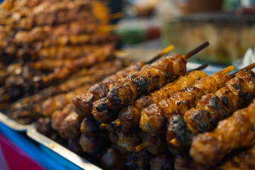 Vietnamese Street food. All kind of meats on the grill stove in Saigon market at night