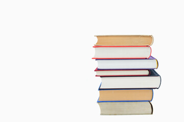 Isolated books, stacked over one another in front of a white background