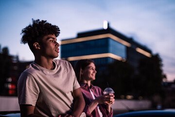 Portrait of attractive young guy spending time with his girlfriend, sitting in the car while...