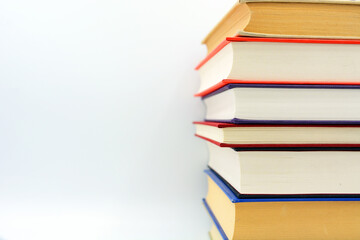 Isolated books, stacked over one another in front of a white background