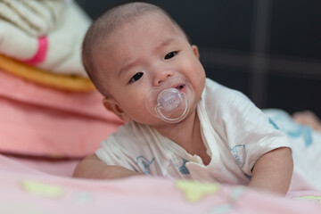 Asian Baby boy with Pacifier in mouth