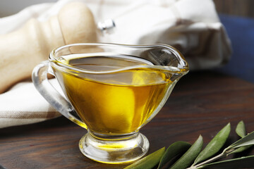 Gravy boat with olive oil close-up on a blue background.