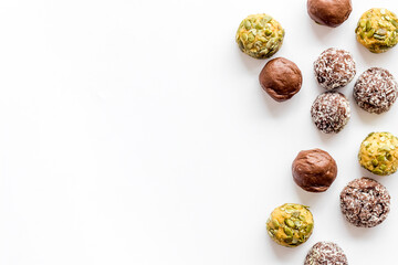 Flat lay of raw protein energy balls with nuts and cacao, top view