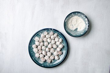 Flour dumplings and flour on a plate