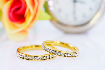 Two golden wedding rings on white