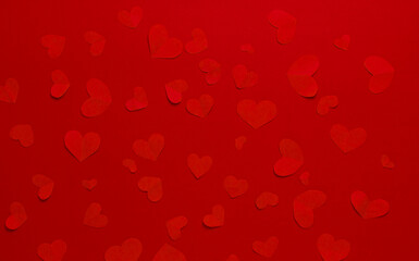 Many red hearts on a red background. Festive background. Background for design. Top view. St. Valentina.