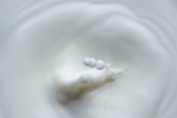 Milk or cream drop falls from the top.
