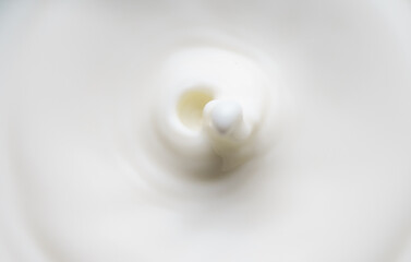 Fototapeta na wymiar Milk or cream drop falls from the top.