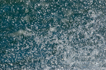 drops and splashes of water on blue background