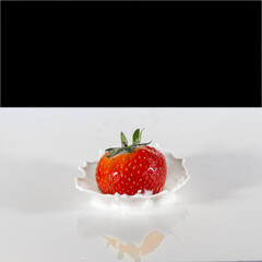 Strawberry splashing in white liquid