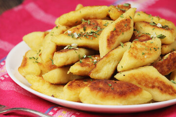 Polish dish kopytka served at the table