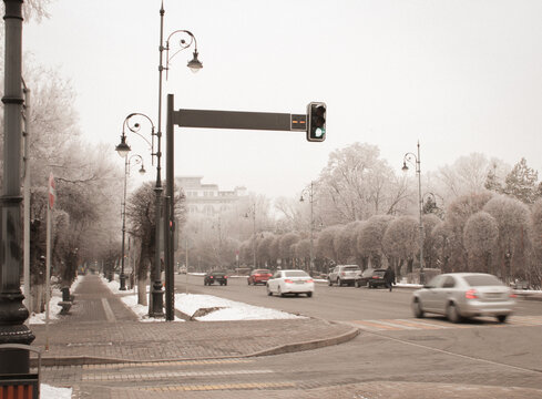 Cloudy winter street scene with cars