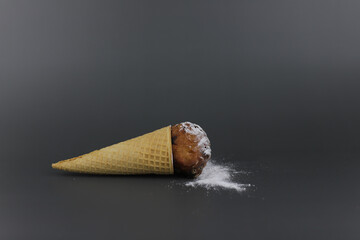 Dutch authentic donut in cornet with raisins and sugar powder on New Year