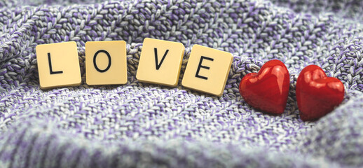 Love banner, valentine's day composition with word love made with scrabble, two red glass heart, love concept, couple, romantic