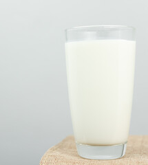 The glass of fresh milk on sackcloth for a background. Raw milk is high in calcium and protein to drink for all ages..Milk consumption nutritious and healthy dairy products concept.