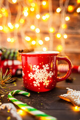 Christmas coffe in red mug on background with lights - obrazy, fototapety, plakaty