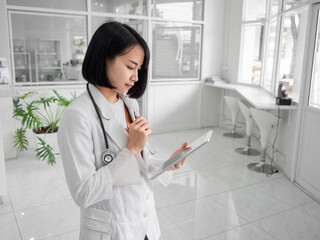female doctor in the hospital, working or study patient chart, professional in uniform wear stethoscope working on how to fight for people. healthcare and medical-care concept.
