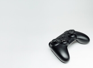 Close up shot of black matte game controller isolated on white. Modern entertainment concept. Space for copy.