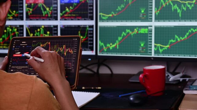 Man analysis forex concurrency stock graph market for trading forex to profit by order sell or buy in night at home