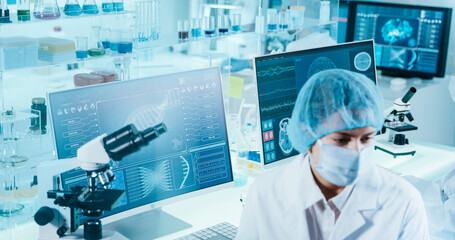 Female scientist studying brainwave scanning models and DNA sequences