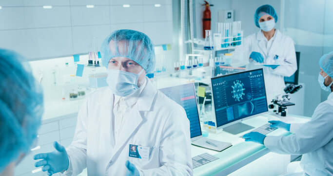 Scientists studying coronavirus models and DNA sequences. Discussing research results - Powered by Adobe