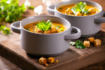 Bowls of homemade organic soup with carrots and potato