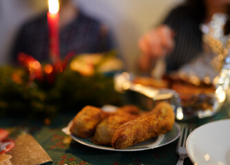 Traditional typical Czech christmas dinner with candles and fish meat