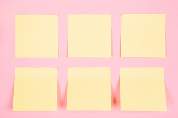 Banner with a clean yellow stickers on a pink background with place for text. Business concept. Tear-off paper for notes, reminders or quick temporary messages, organazer of thoughts and ideas