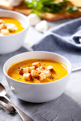 Bowls of homemade organic soup with carrots and potato