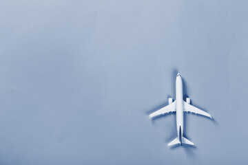Naklejka na ściany i meble Model of passenger airplane on paper background. Classic blue tone
