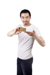 A young business man holding credit card 