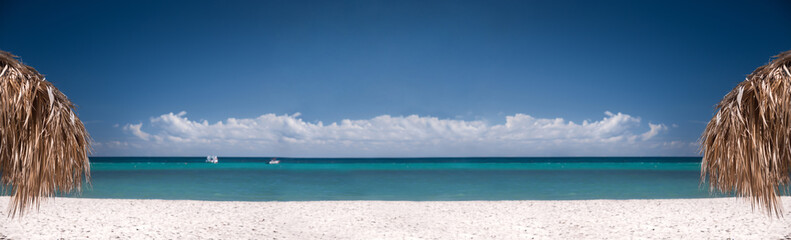 Fototapeta na wymiar Tropical shore with thatched palapa. View on caribbean sea