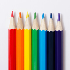 Multi-colored pencils on a white background.